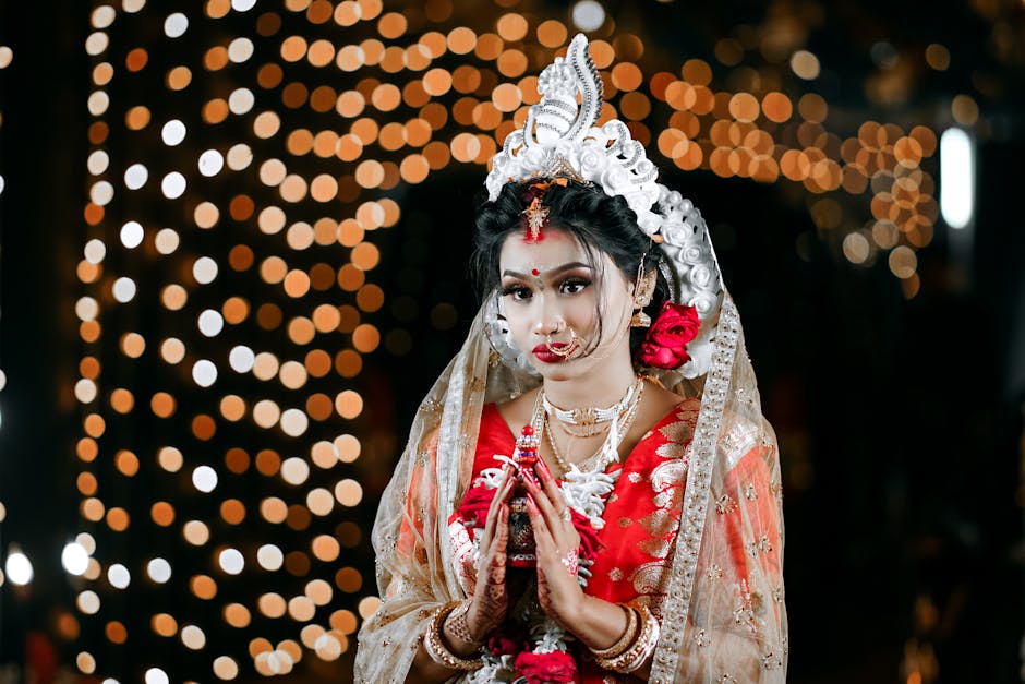 Professional bridal makeup artist applying makeup to a bride in Udaipur with traditional wedding jewelry