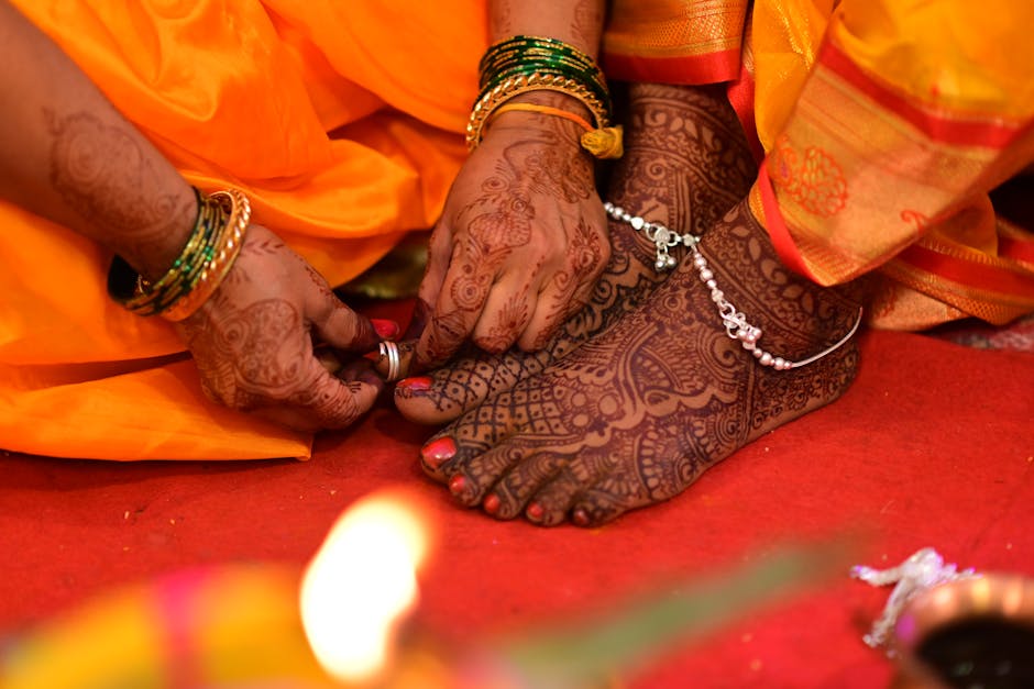 Intricate bridal mehndi design being applied to bride's hands in Udaipur
