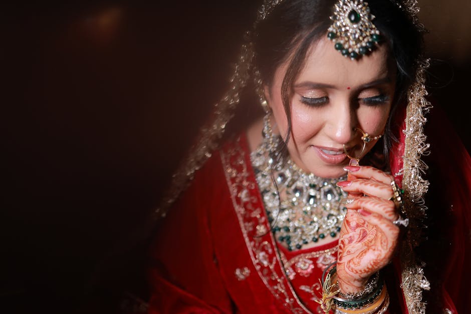 Bride trying on custom-designed wedding outfit with designer assistance in Udaipur studio