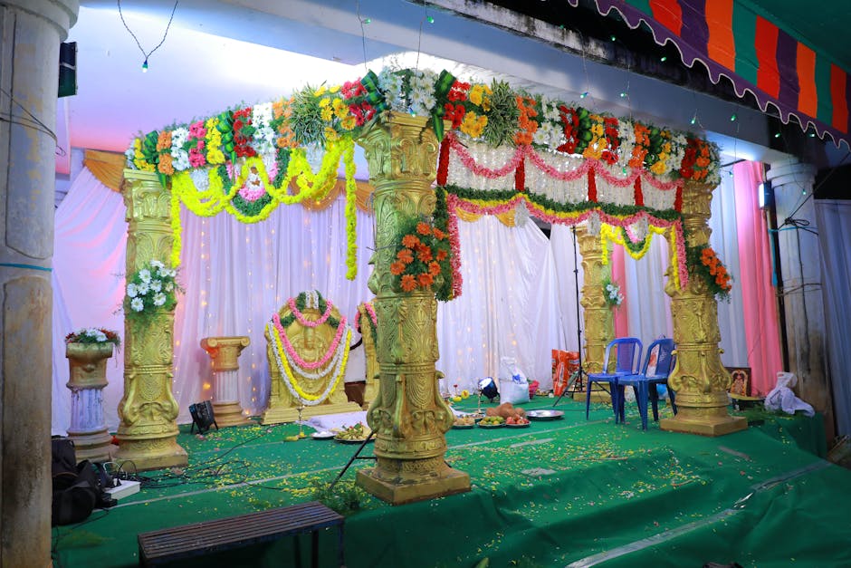Grand wedding stage setup with floral decorations and traditional lighting in Udaipur