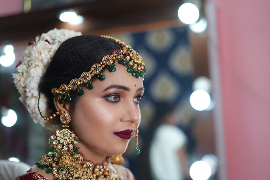 Professional bridal makeup artist applying makeup to a bride in Udaipur with traditional wedding jewelry